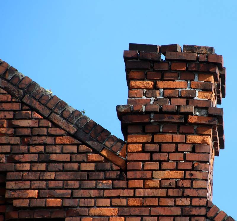 Signs Your Lake Zurich Home Needs a Chimney Inspection Damaged chimney on an Lake Zurich home showing cracks and missing mortar
